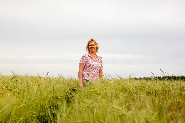 istock Mature woman walking through cornfield 182811426
