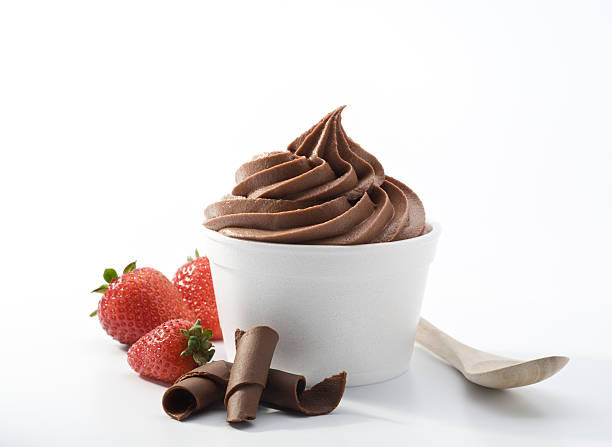 Chocolate Frozen Yogurt - XXXL SEVERAL MORE IN THIS SERIES. Cup of frozen soft-serve chocolate yogurt with fresh strawberries and chocolate curls and eco-friendly bamboo spoon.  XXXL high resolution shot. frozen yoghurt stock pictures, royalty-free photos & images