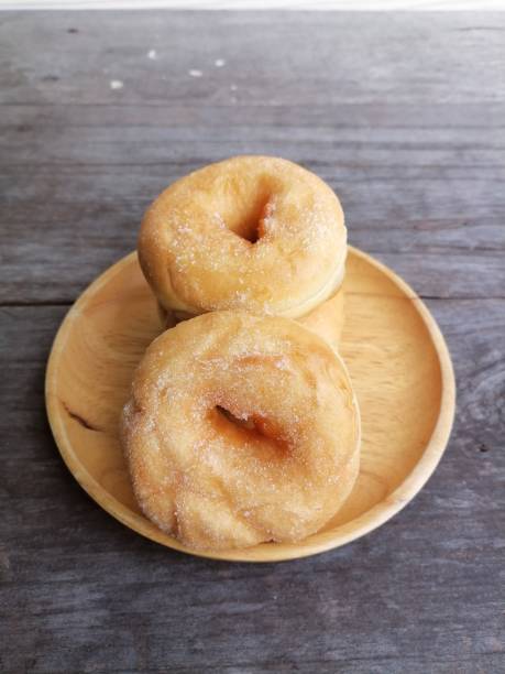 istock Donut with sugar bakery on table wood background 1828120249