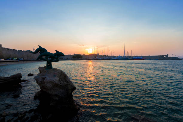 Mandraki port in Rhodes Town, Greece, and St Nicholas fortress in the background, UNESCO World Heritage Site, Rhodes City August 5, 2016