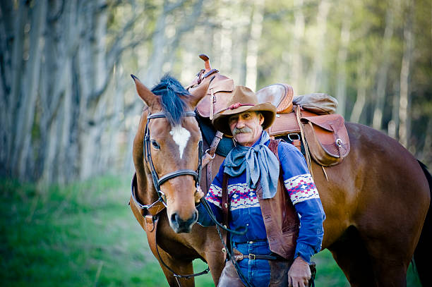 istock Old cowboy with horse in woods 182812334