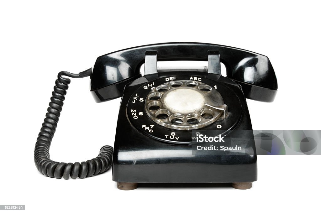 A black vintage rotary dial telephone A black rotary telephone, isolated on a white background. Telephone Stock Photo