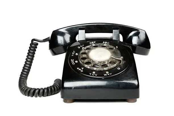 Photo of A black vintage rotary dial telephone