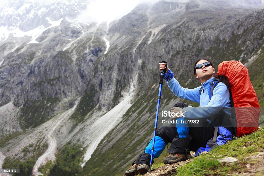 Młoda kobieta Turysta z plecakiem siedzący na góry - Zbiór zdjęć royalty-free (20-24 lata)