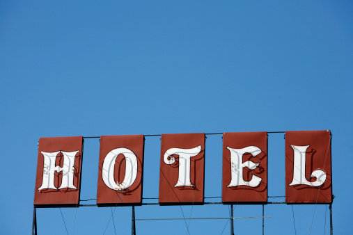 Original Red and white neon hotel sign with blue background. Located in Nelson BC