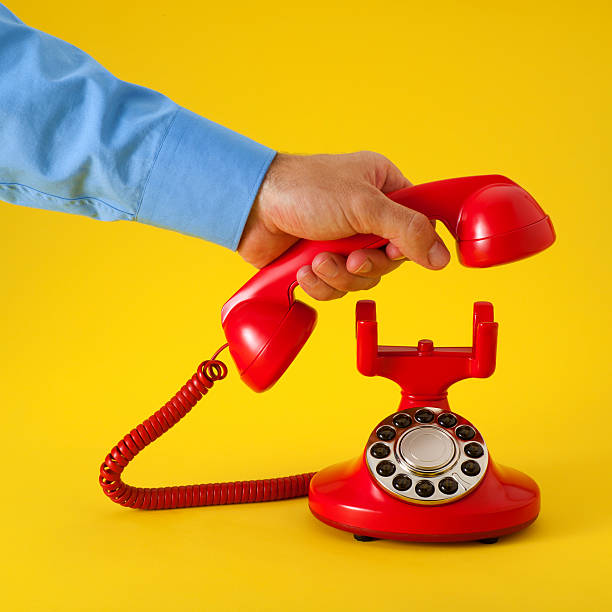 istock Answering a Red Old Fashioned Telephone on the Yellow Background 182813810