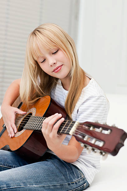 istock Young Girl Playing Guitar 182813993