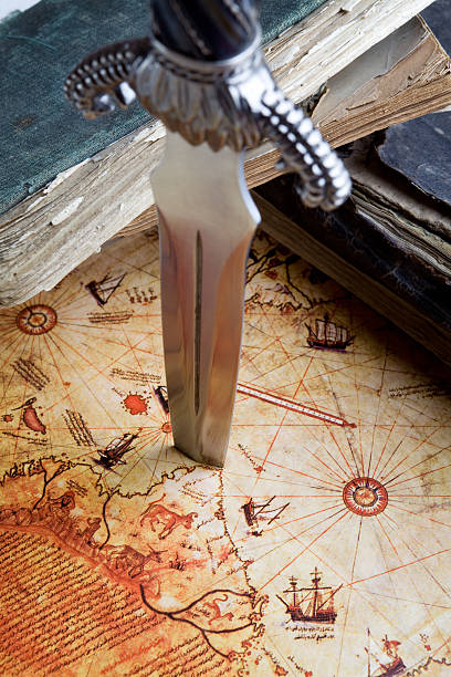 istock Full Frame Antique Books And Dagger On Map Background 182814135