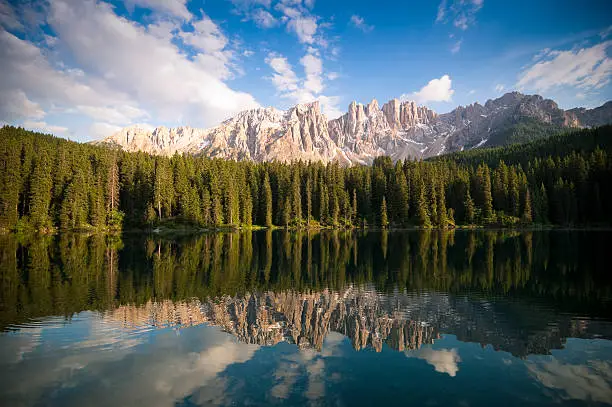 Spectacular views of Carezza Lake and the Dolomites (Latemar Group, South Tyrol, Alps).
