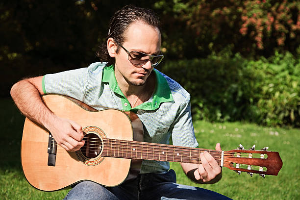 istock Greek musician playing his guitar 182814592