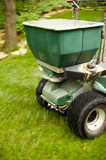 istock Riding Fertilizer Spreader Applying to Lawn 182814680