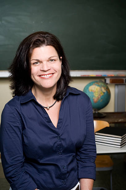 istock Female Teacher in front of chalkboard 182815252