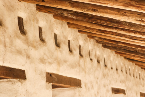 Mission San Juan Bautista stucco facad and ceiling beams along its long outdoor veranda.  San Juan Bautista, California, 2009.