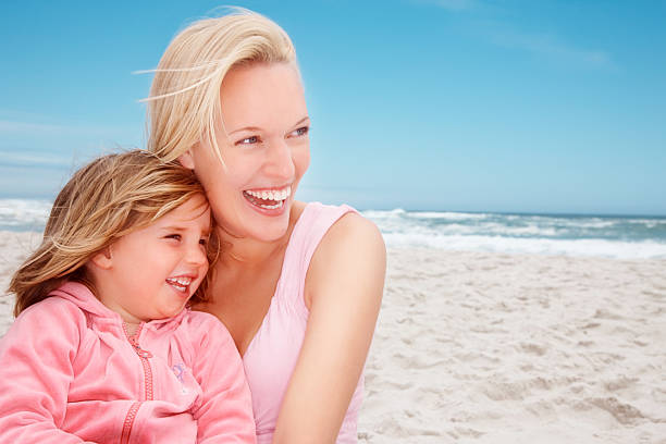 istock Cheerful woman with her daughter at beach 182816181