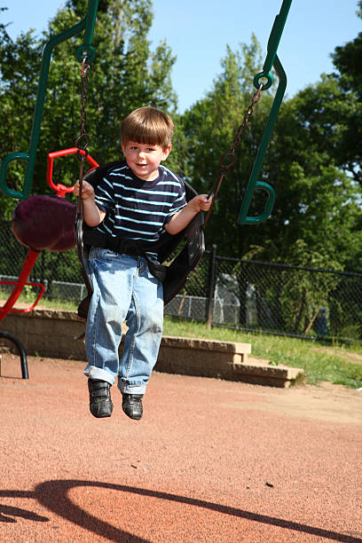 istock Boy Swinging In Park Playground 182817090