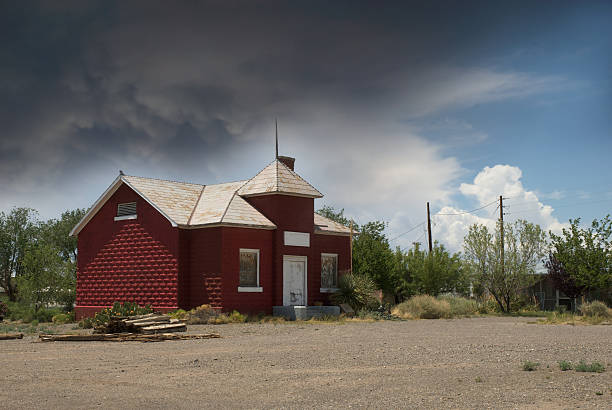 Red schoolhouse or building in a storm stock photo