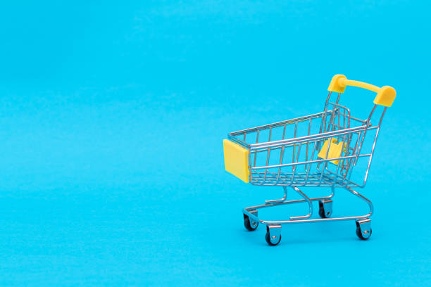 istock Empty Yellow Shopping Cart on Blue Background 1828179838
