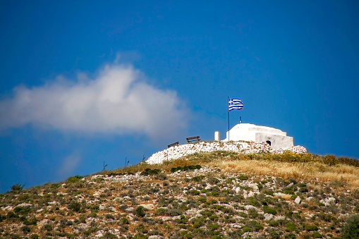 White small greek orthodox chapell on the hill