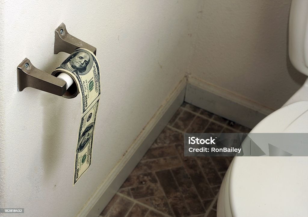 Hundred Dollar Toilet Paper Roll A toilet paper roll of $100 bills in a grungy bathroom Abundance Stock Photo