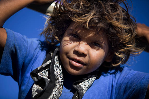 A photograph of a child wearing a black bandana  stock photo