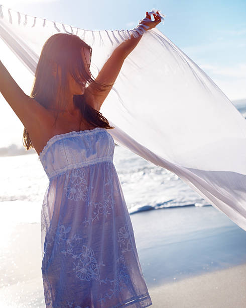 istock Happy woman holding a stole at beach 182819192