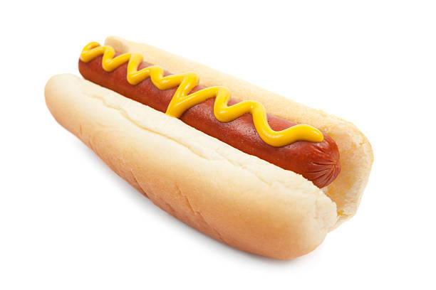 A hot dog on a bun with mustard A delicious hot dog with mustard, on white. Check out some other White Backgrounds here. hot dog stock pictures, royalty-free photos & images