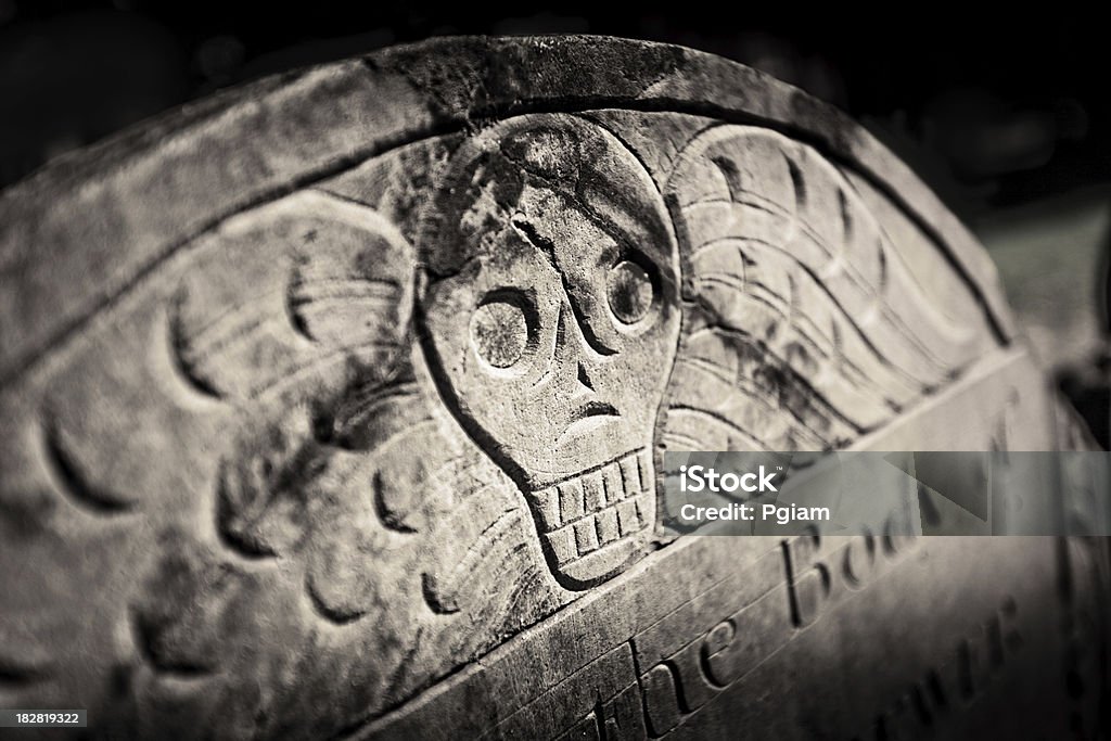 Skull headstone Grave stone with a skeleton in a cemetary Boston - Massachusetts Stock Photo