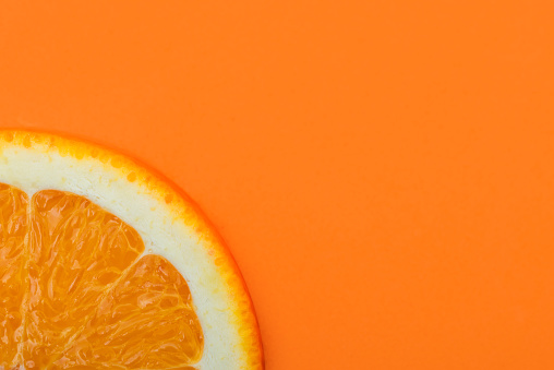 a slice of orange on an orange background