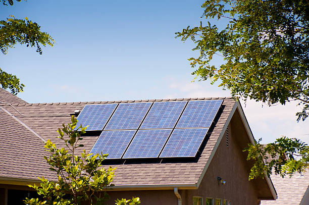 Solar Panels Back View Residential solar panels on back rooftop. rooftop solar stock pictures, royalty-free photos & images