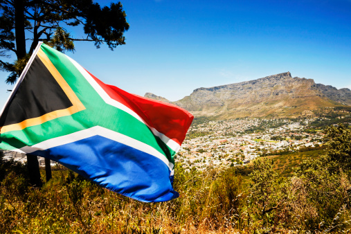 South Africa's multicoloured national flag waves in front of Cape Town's Table Mountain. Shot with Canon EOS 1Ds Mark III.
