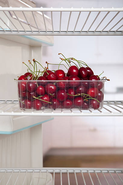 cherries in fridge stock photo
