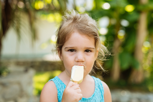 Girl licking ice cream in summertim