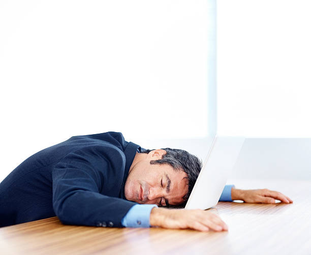 istock Tired business man resting on his laptop 182821676