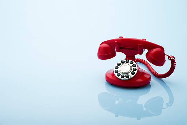 istock Red Old Fashioned Telephone on a Blue Background 182821762