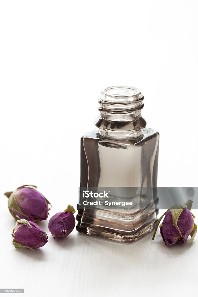 Rose Oil Aromatherapy oil with dried roses. Alternative Medicine Stock Photo