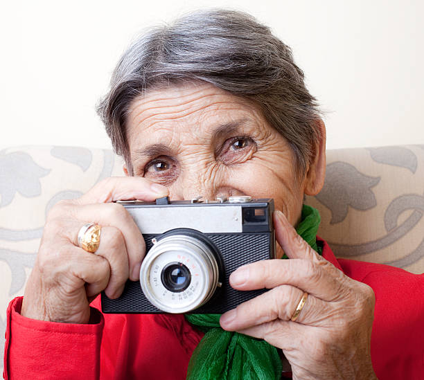 istock Senior woman holding a camera 182822648