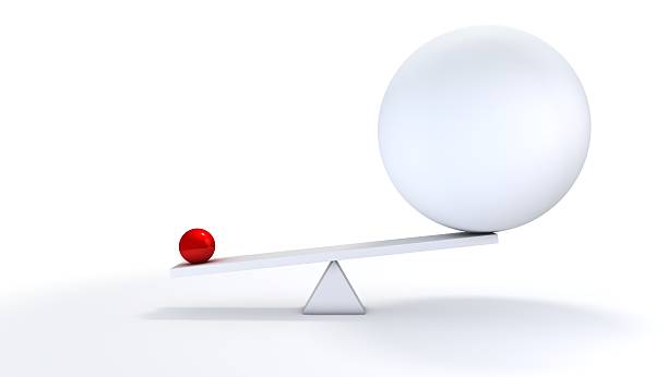 Small ball out balance. "A small concentrated ball has more weight than its bigger, less defined competitor.You may also like:" giant stock pictures, royalty-free photos & images