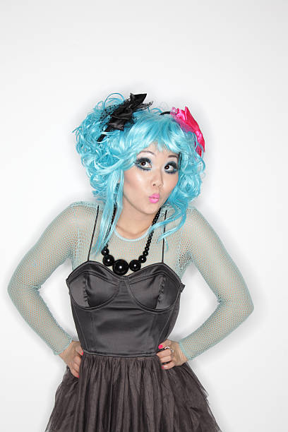Manga Girl posing against plain studio background.