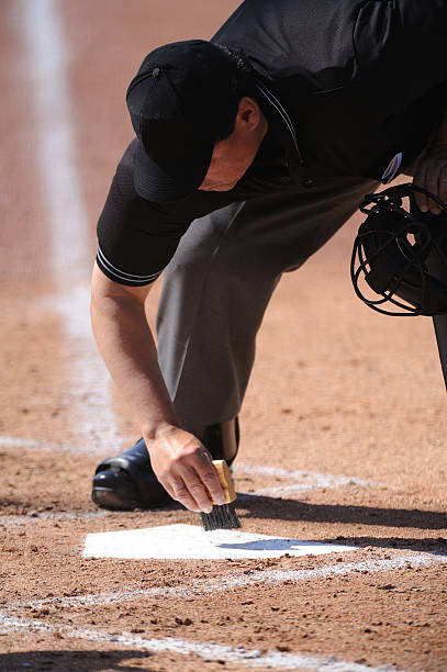 istock Sweeping off the home plate for baseball game  182826381