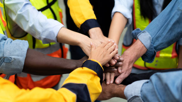 istock teamwork of diverse worker stacking hands together motivate team building 1828264699