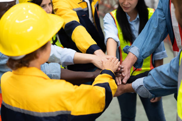 istock group of multiracial colleagues joining hands in morning meeting 1828264708
