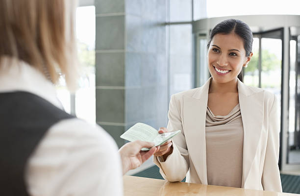 istock Airline Attendant Hands Documentation to a Businesswoman 182826493