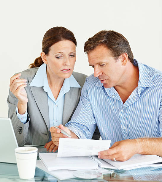 istock Paperwork - Successful colleagues discussing business 182826619