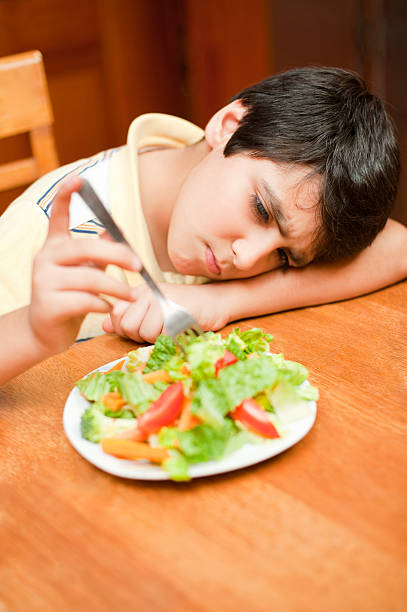 istock Unhappy boy with his food 182827537