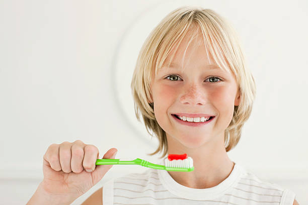 istock Young Boy Smiling and Holding Toothbrush 182827672