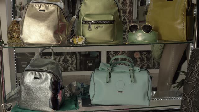 steady cam on the window of an accessories shop with various types of women's bags displayed