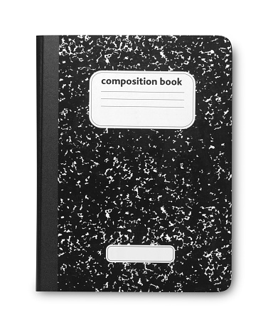 A student's old black and white marble composition book. Scratches on cover due to old nature of book. Isolated on white with soft shadow.