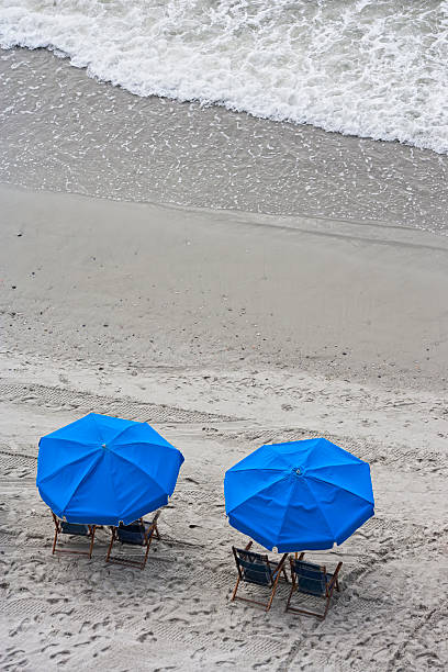 istock Blue beach umbrellas at the shore 182830796