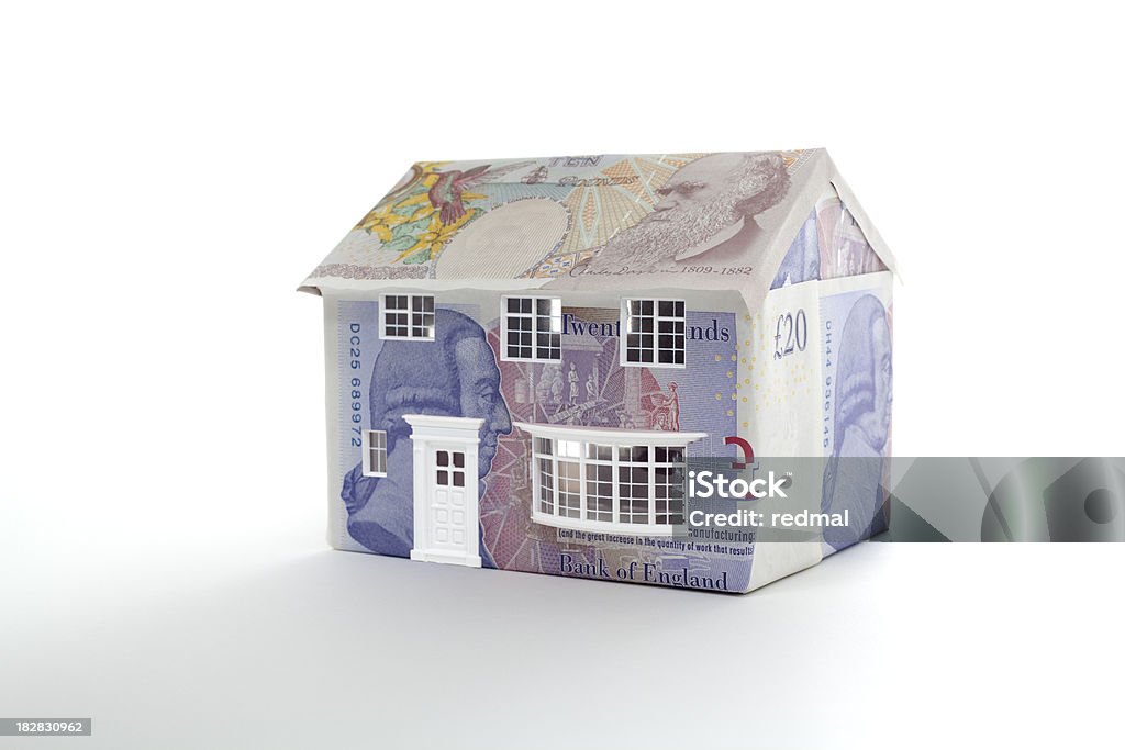 British property house made of british notes on white background British Currency Stock Photo