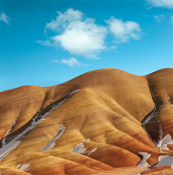 Painted hills, Oregon, USA "Close-up of the spring thaw at the painted hills, Oregon. Snow is showing in the protected folds of this natural landscape.see #13602327 for close up." east photos stock pictures, royalty-free photos & images